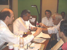 Dr. Mitchell of Raleigh, NC, performing an Ayurvedic pulse assessment for a patient with his renowned teacher Dr. Pankaj Naram.
