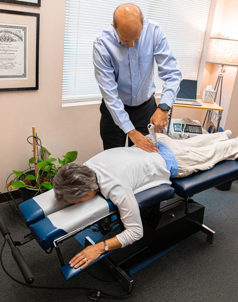 Dr. Thomas Mitchell, DC, performing a chiropractic adjustment