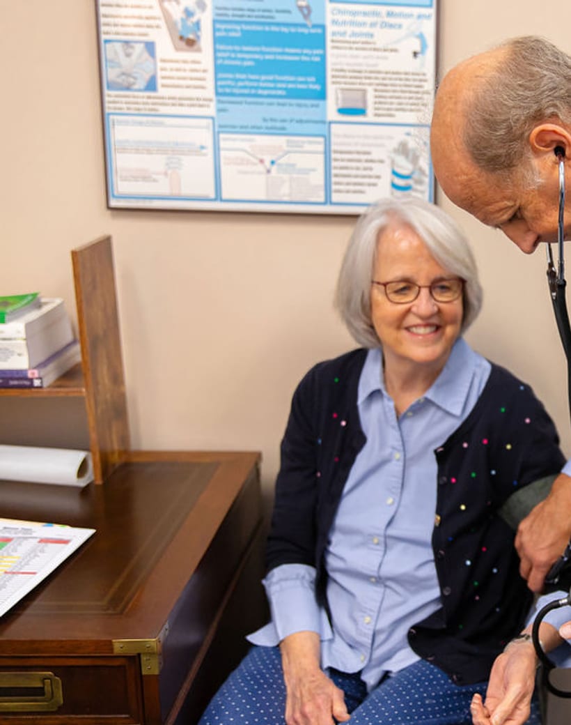 Dr. Thomas Mitchell, DC, reviewing a patient's diagnostics